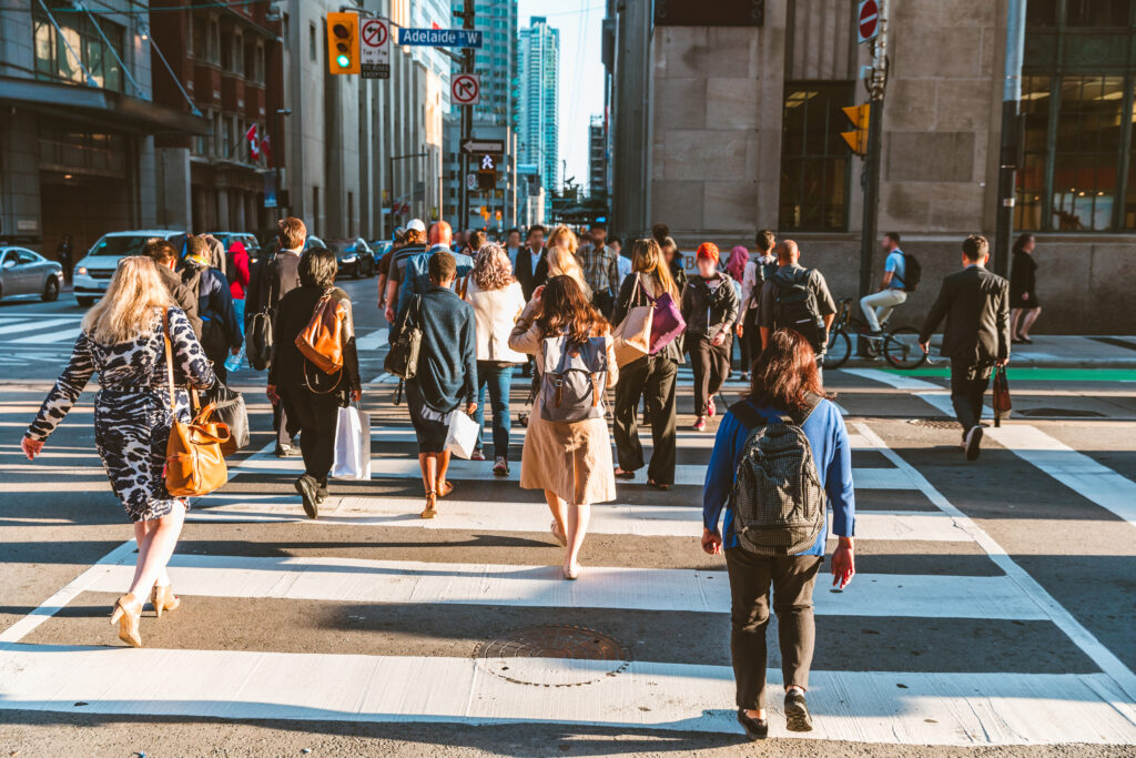 pedestrians walking across a cross walk in alexandria