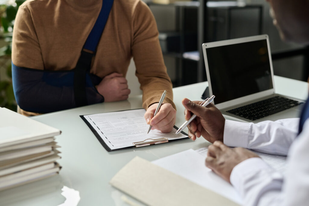 injured man speaking with a car accident lawyer