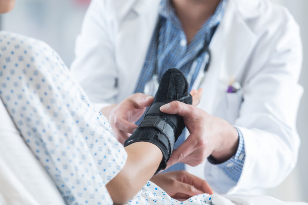 doctor touching a womans cast who was in a personal injury accident due to someone's recklessness