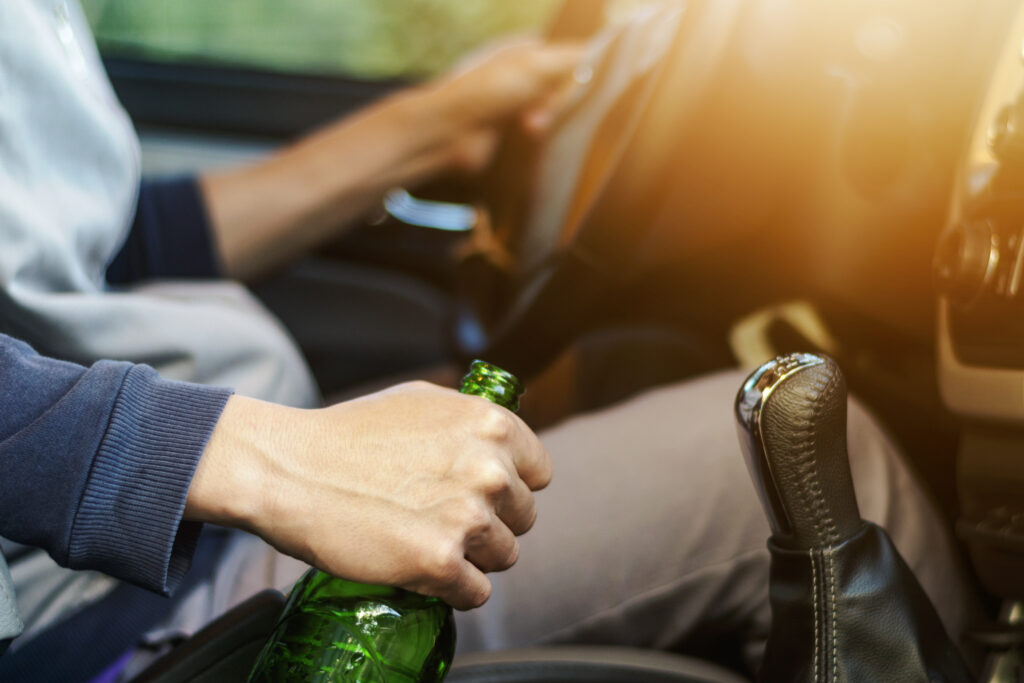 Drinking and driving ,man drinking alcohol and driving car