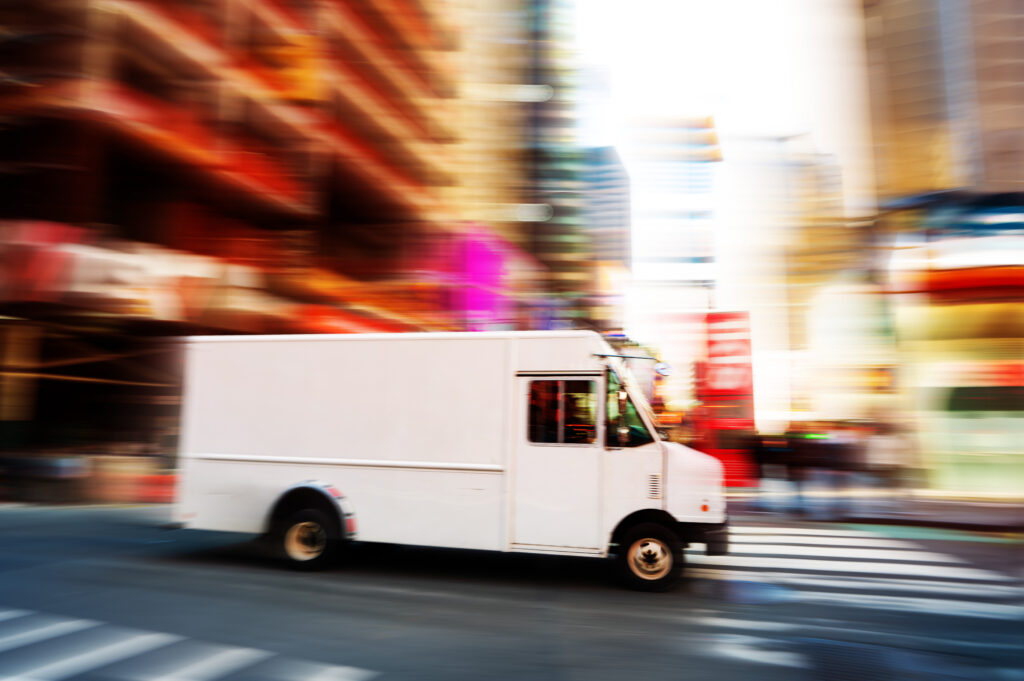 white van speeding through intersection