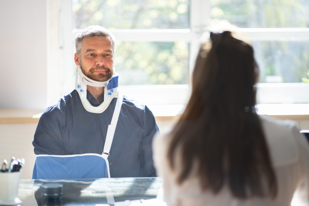 man with whiplash injury getting the help of a car accident lawyer