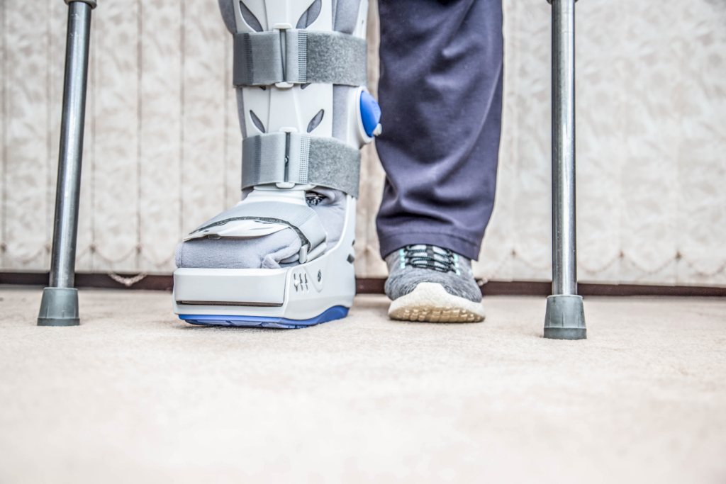 picture from the knee down of a personal injury victim with crutches and a boot