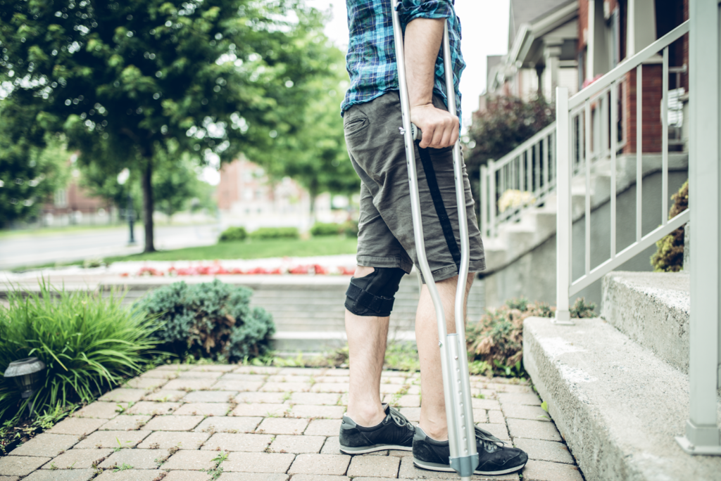 man with crutches about to go up stairs after a personal injury