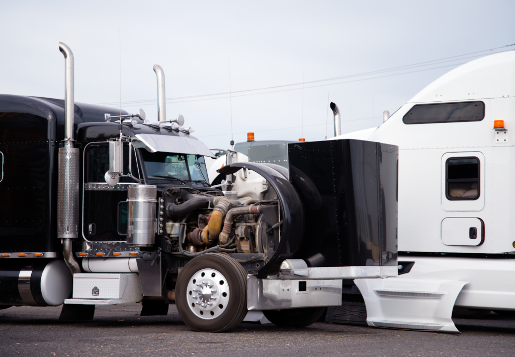 truck in a truck lot with engine open after an accident