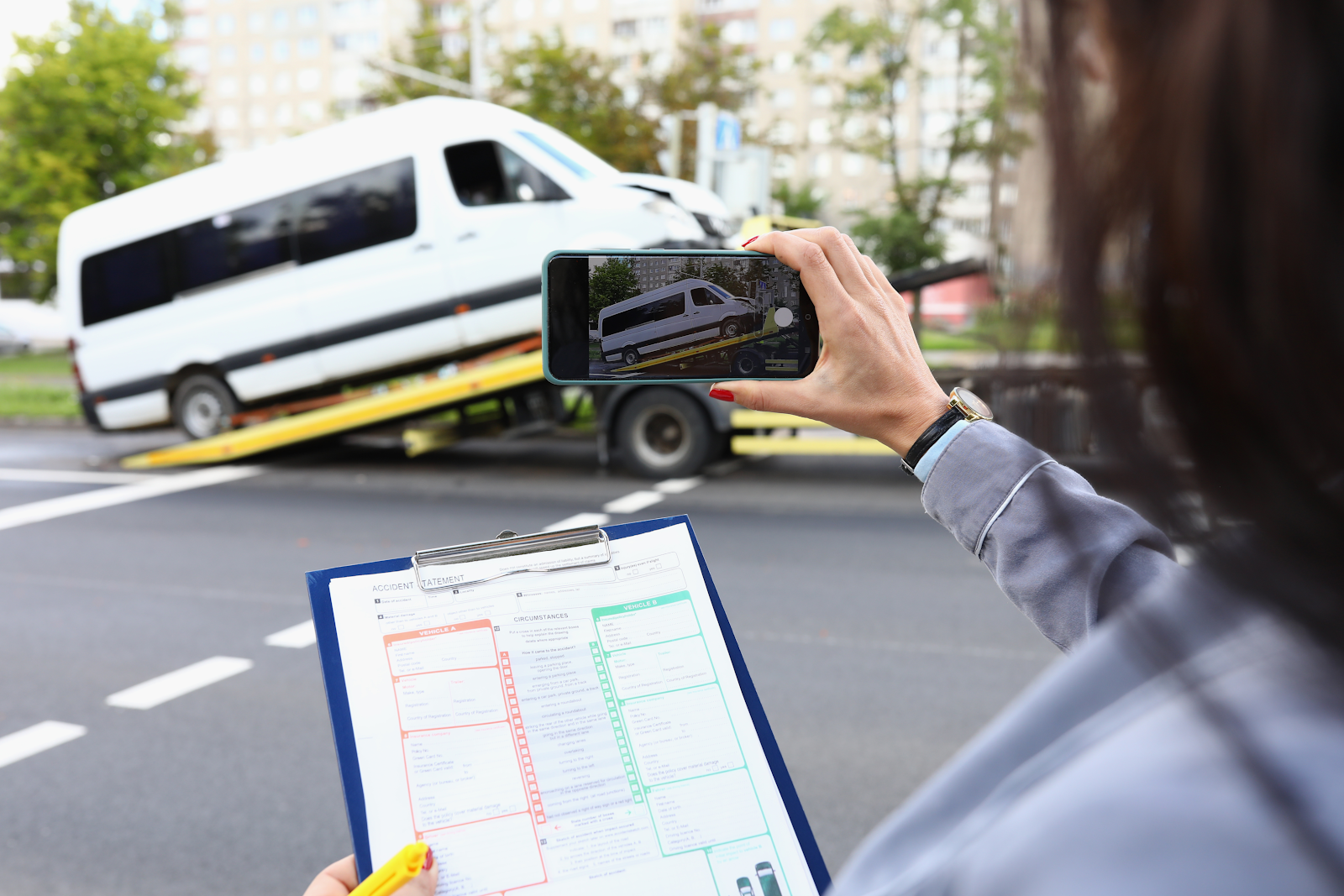 nationwide mutual insurance company adjuster taking a picture of a damaged van