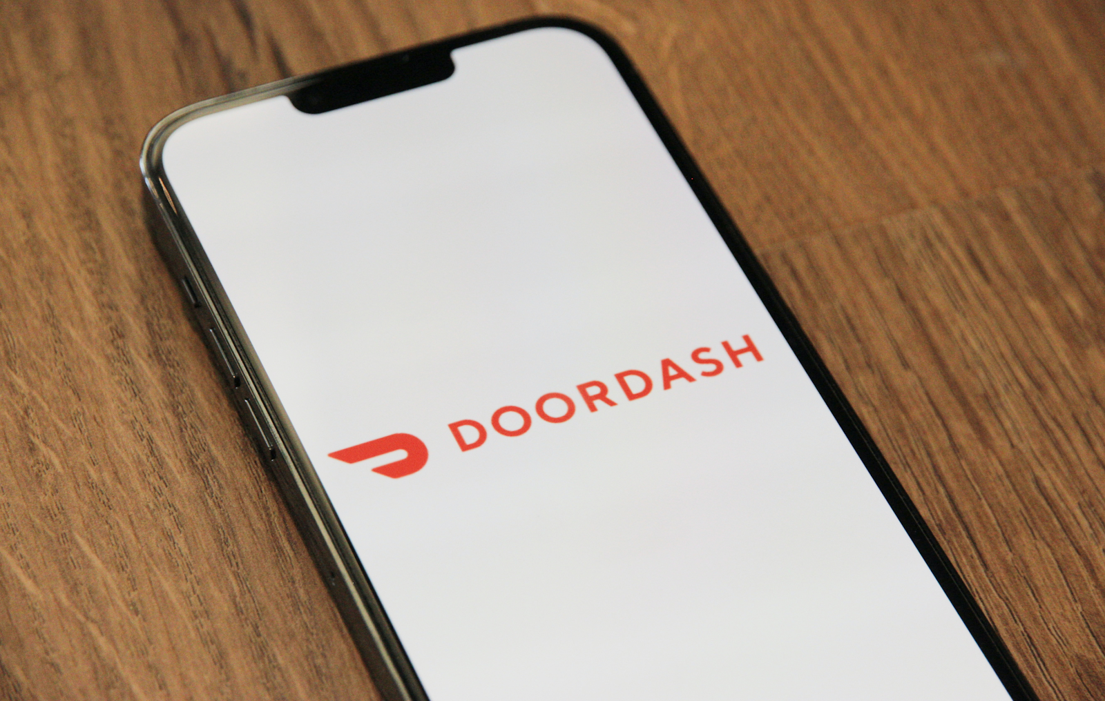 doordash app opening on a phone, food delivery services accidents theme