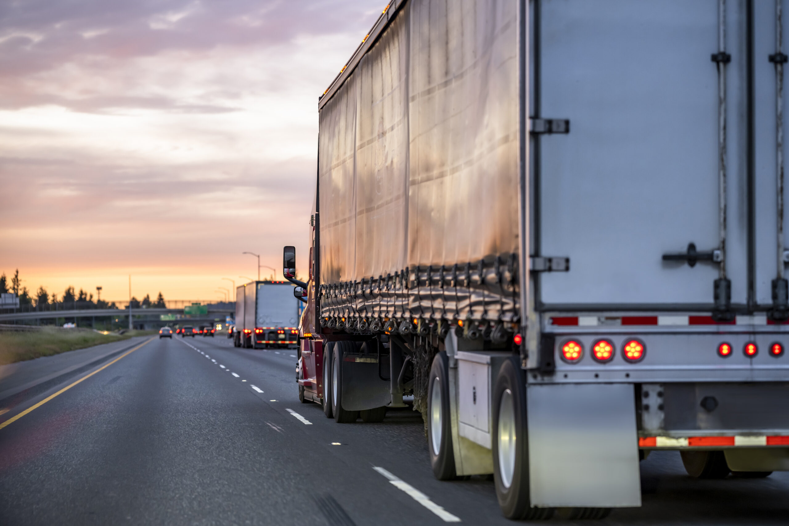 Semi-trucks travel on a busy highway, which is a dangerous time for blind spot truck accidents.