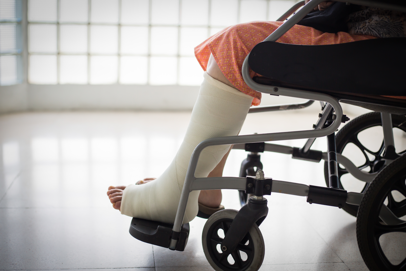 man in a wheelchair with a cast on his foot.