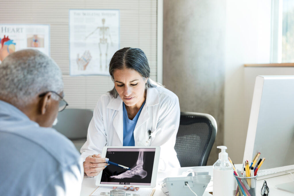 A patient with a personal injury claim reviews an x-ray with their doctor.