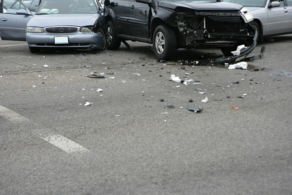An accident scene involving many cars that are damaged.